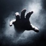 human-hand-on-dark-background.jpg